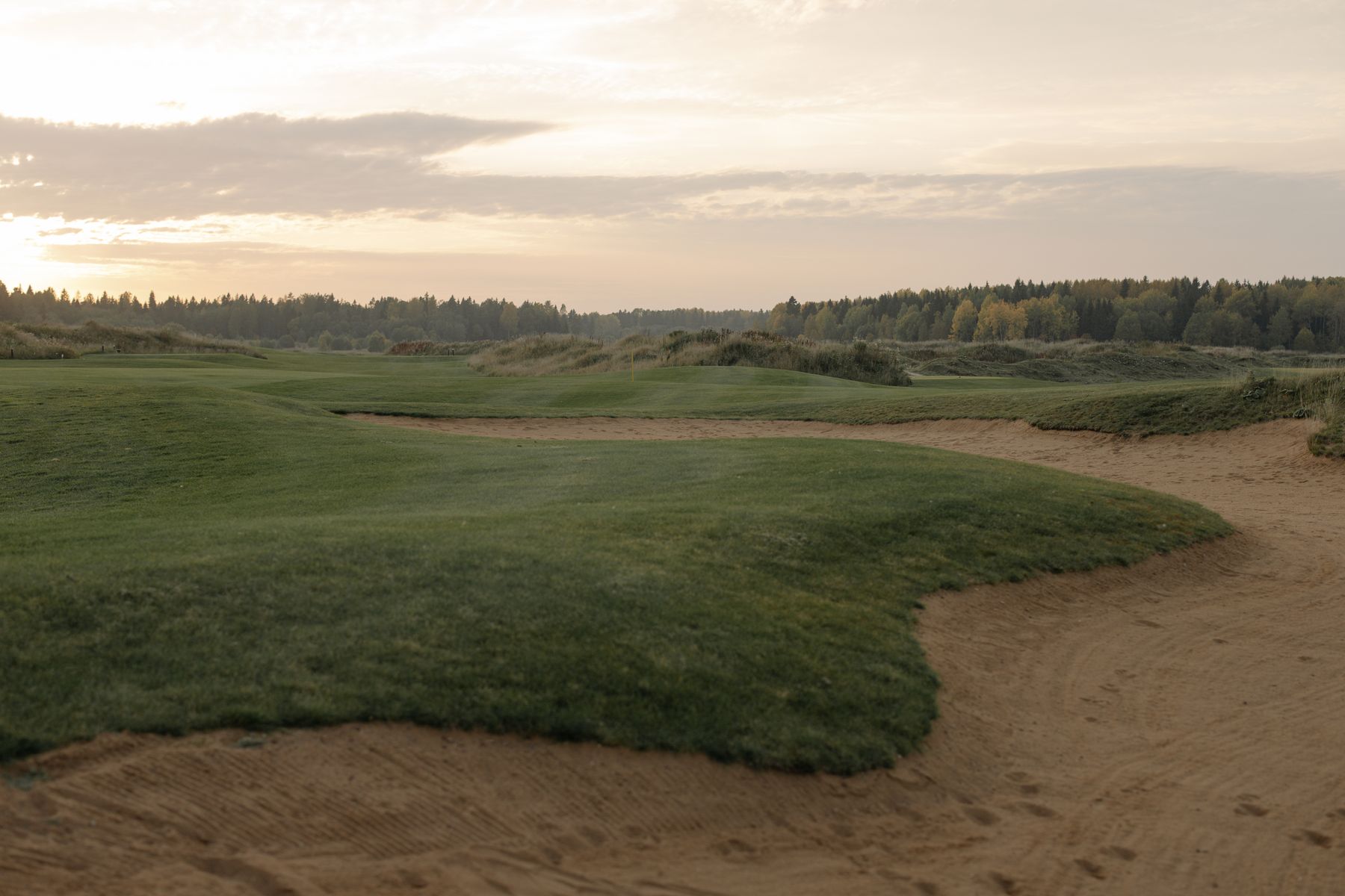 Golf course fairway at sunset