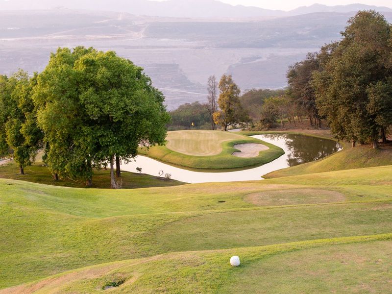 Golf course with fairway and water feature